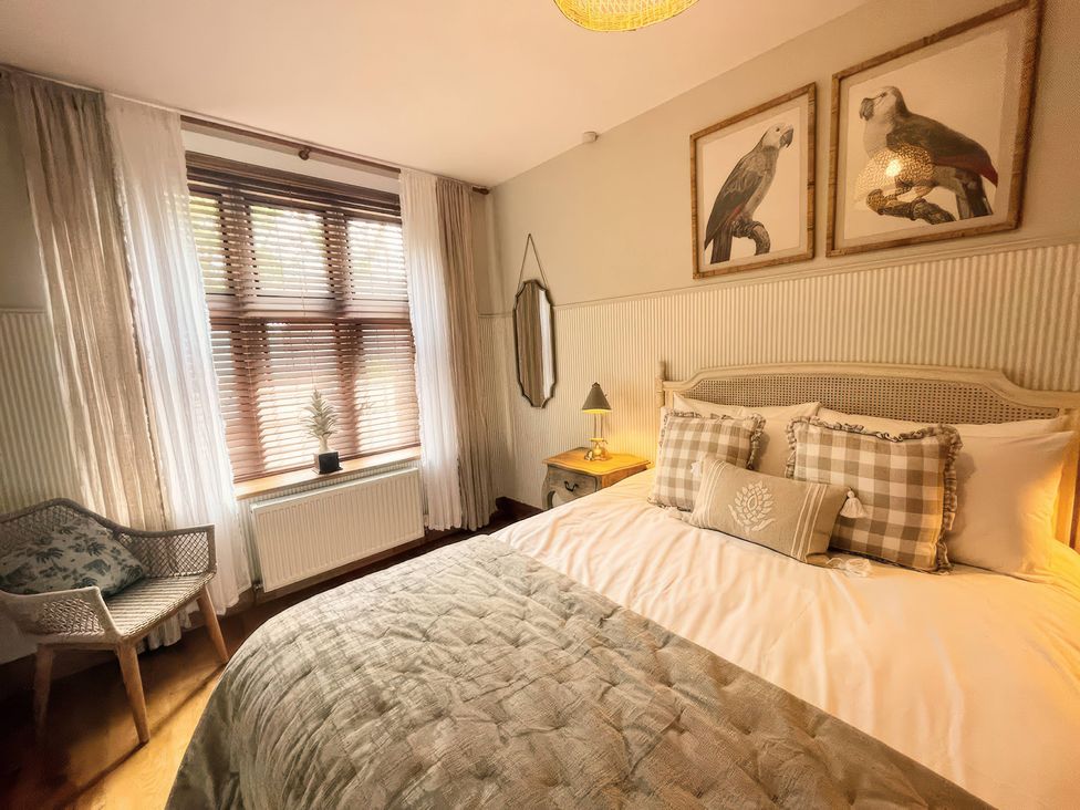 A bedroom with a bed and window at The Lady Rothschild Stables in Peterborough