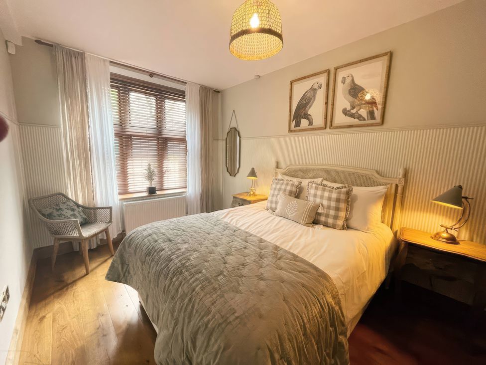A bedroom with a bed and bedside tables at The Lady Rothschild Stables in Peterborough