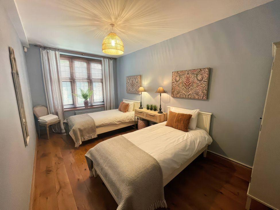 A bedroom with two beds and a window at The Lady Rothschild Stables in Peterborough