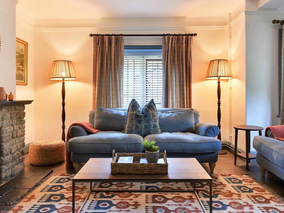A living room with a sofa and coffee table at Home Farm Cottage in Peterborough