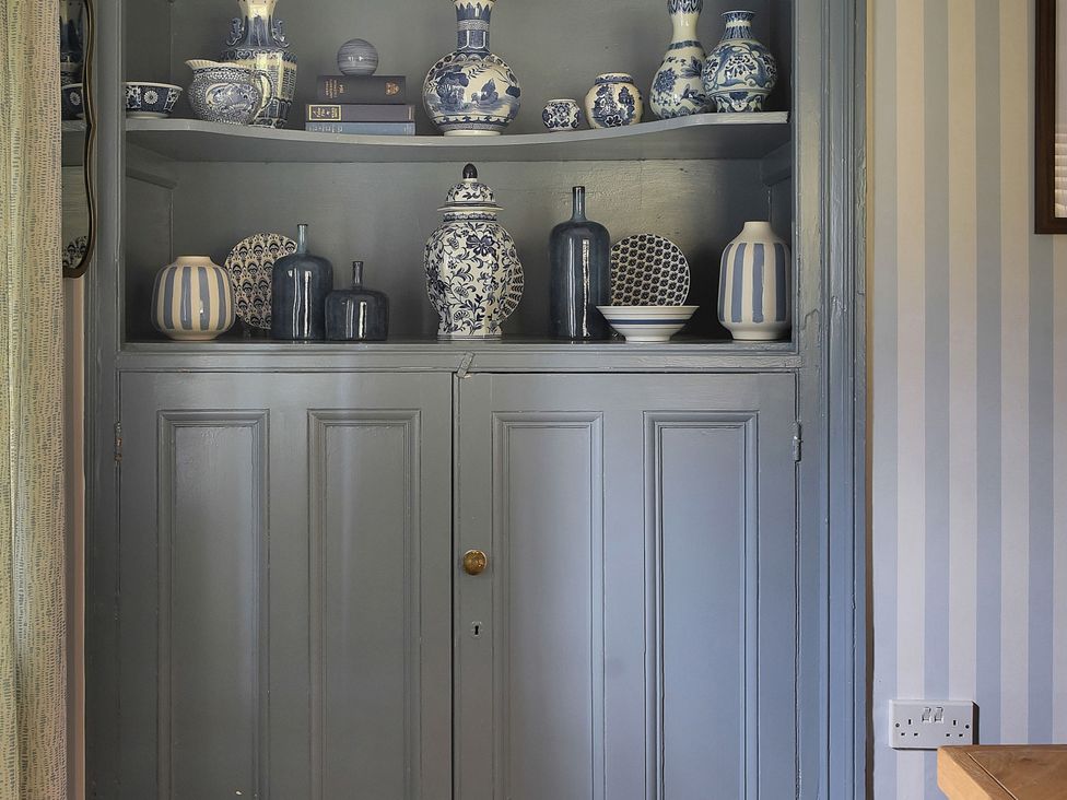 A display of vases and decor items on shelves at Home Farm Cottage in Peterborough
