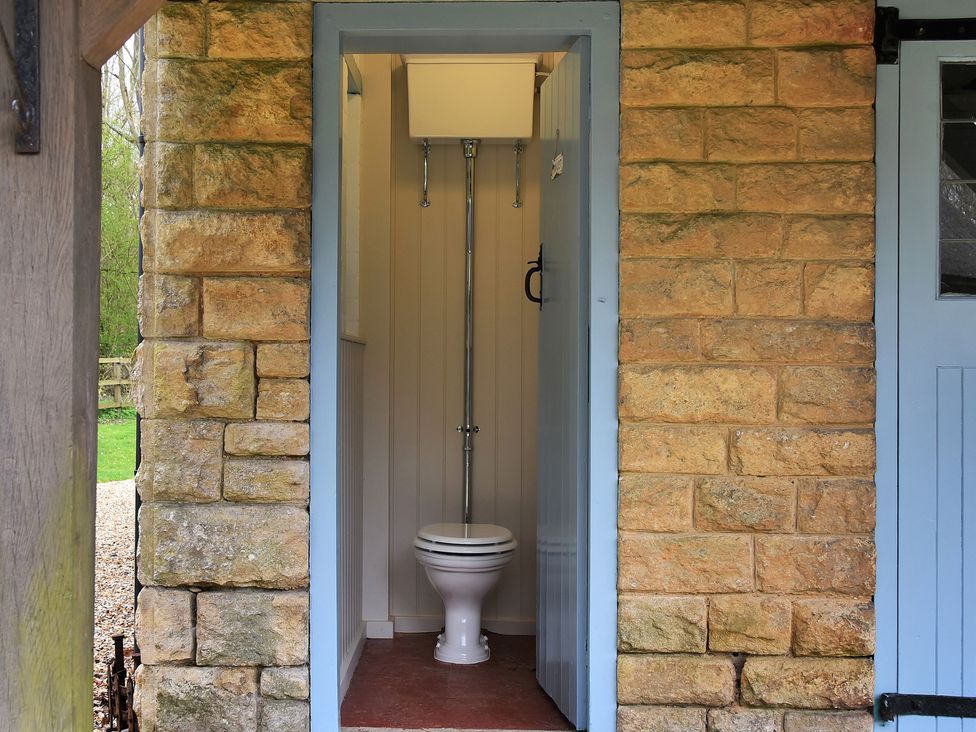 A bathroom with a toilet and sink at Home Farm Cottage in Peterborough