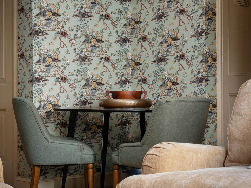 A dining room with a table and chairs at Rubens Rooms Peterborough