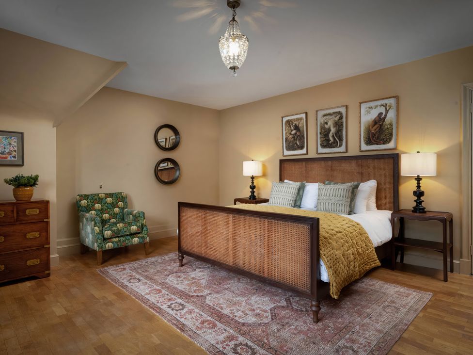 A bedroom with a bed and decorative elements at Rubens Rooms in Peterborough