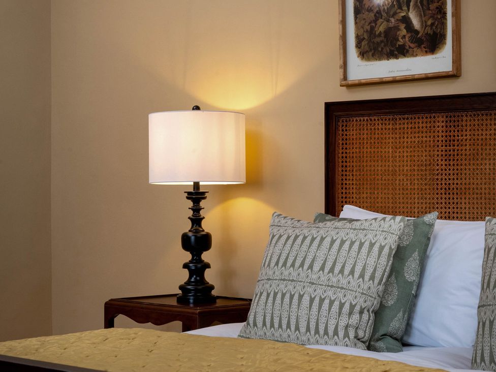 A bedroom with a lamp and bed at Rubens Rooms in Peterborough
