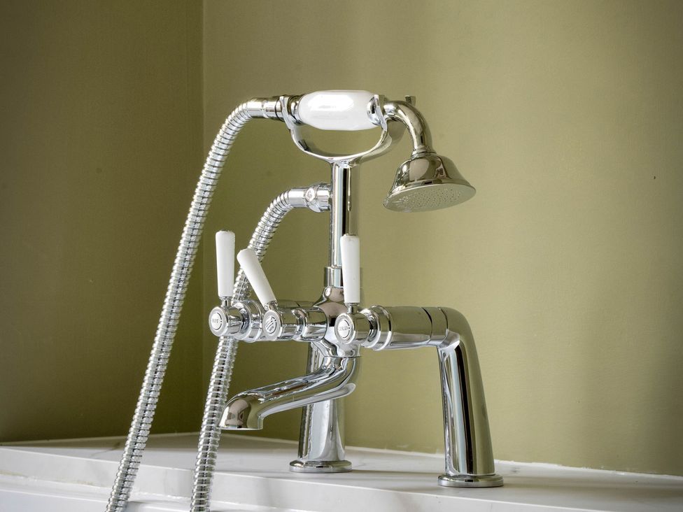 A faucet with a showerhead in a bathroom at Rubens Rooms in Peterborough