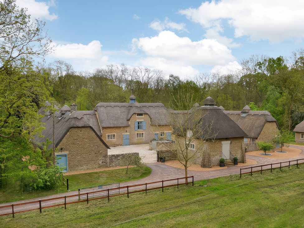 An exterior view of a property with a thatched roof at The Lady Rothschild Dairy in Peterborough
