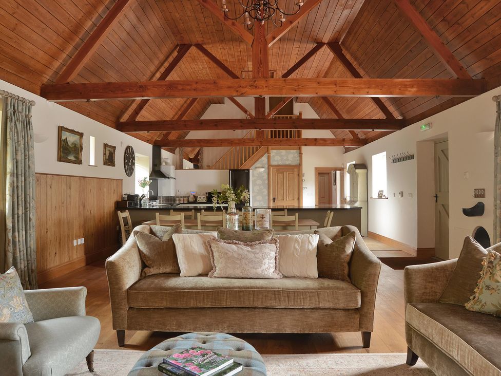 A living room with a sofa and dining area at The Lady Rothschild Dairy in Peterborough