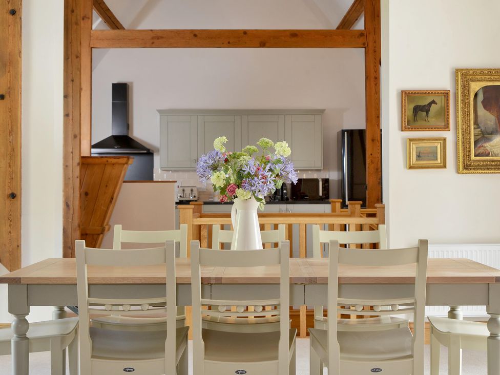 A dining room with a table and chairs at The Lady Rothschild Dairy in Peterborough