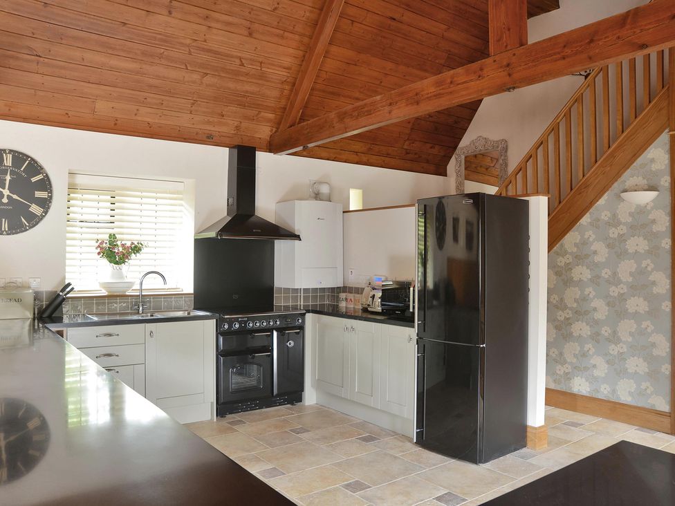 A kitchen with a sink, oven and refrigerator at The Lady Rothschild Dairy in Peterborough