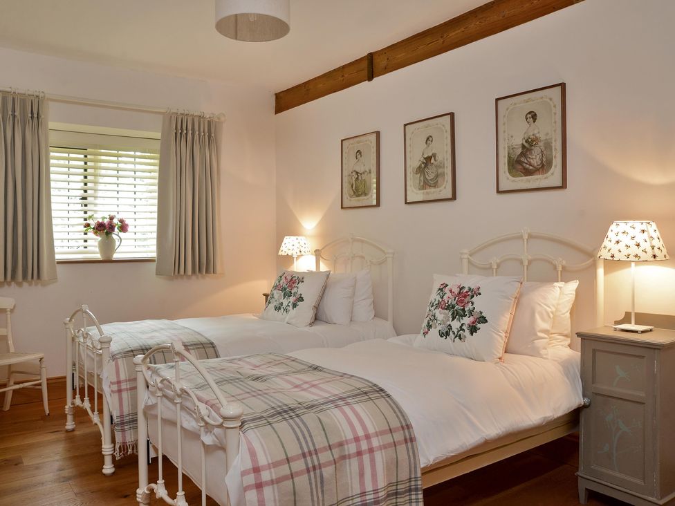 A bedroom with two beds and a window at The Lady Rothschild Dairy in Peterborough
