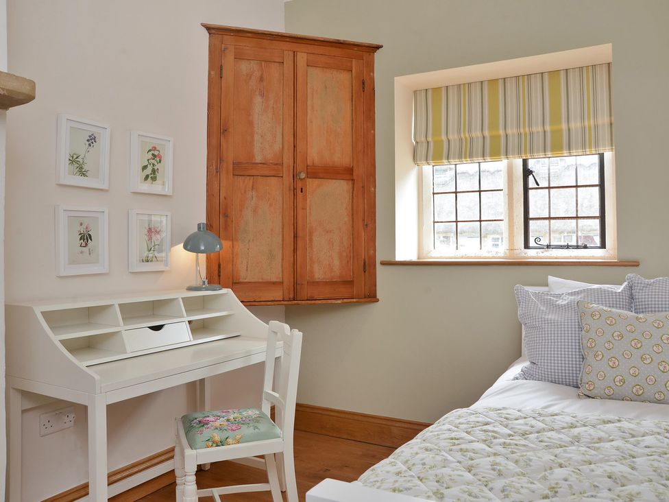 A bedroom with a desk and chair at The Lady Rothschild Dairy in Peterborough
