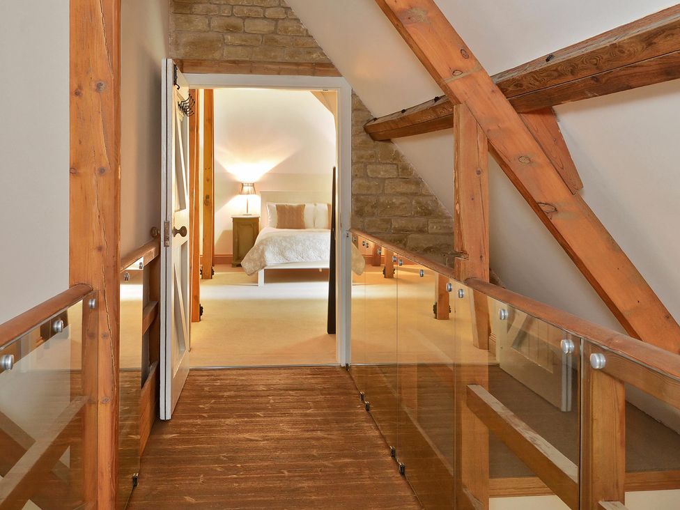 A hallway with a view into a bedroom at The Lady Rothschild Dairy, Peterborough