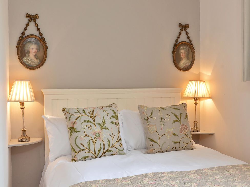 A bedroom with a bed and lamps at The Lady Rothschild Dairy in Peterborough