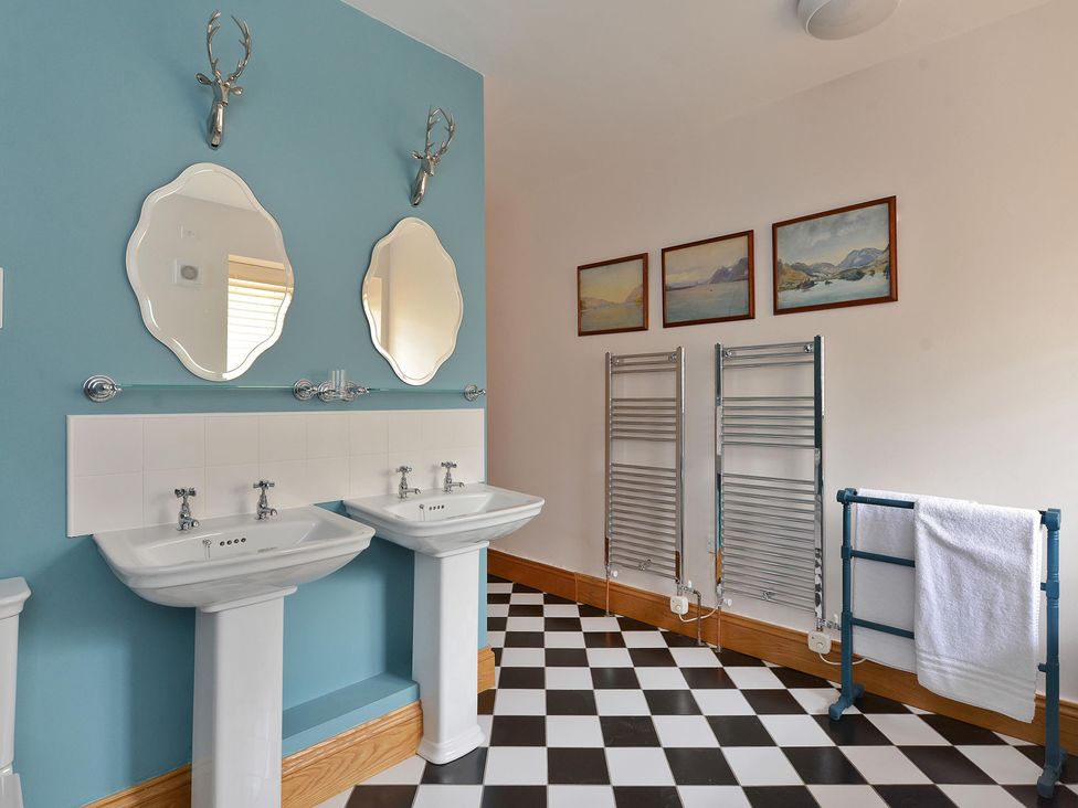 A bathroom with sinks and mirrors at The Lady Rothschild Dairy in Peterborough