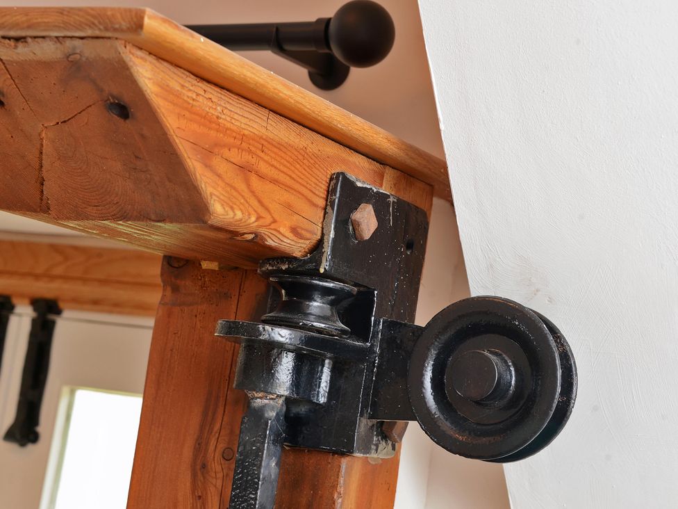 A wooden beam with a metal pulley at The Lady Rothschild Dairy in Peterborough