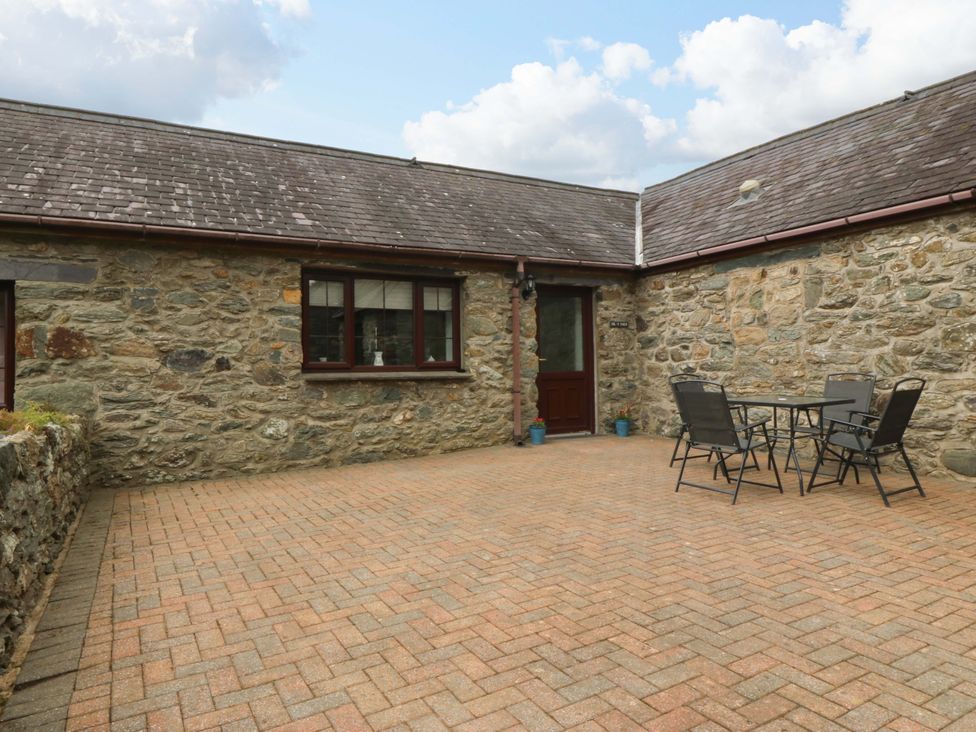 An outdoor area with a table and chairs at Cil Y Coed in Star near Llanfairpwllgwyngyll