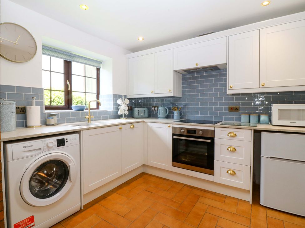 A kitchen with appliances and sink at Cil Y Coed in Star near Llanfairpwllgwyngyll