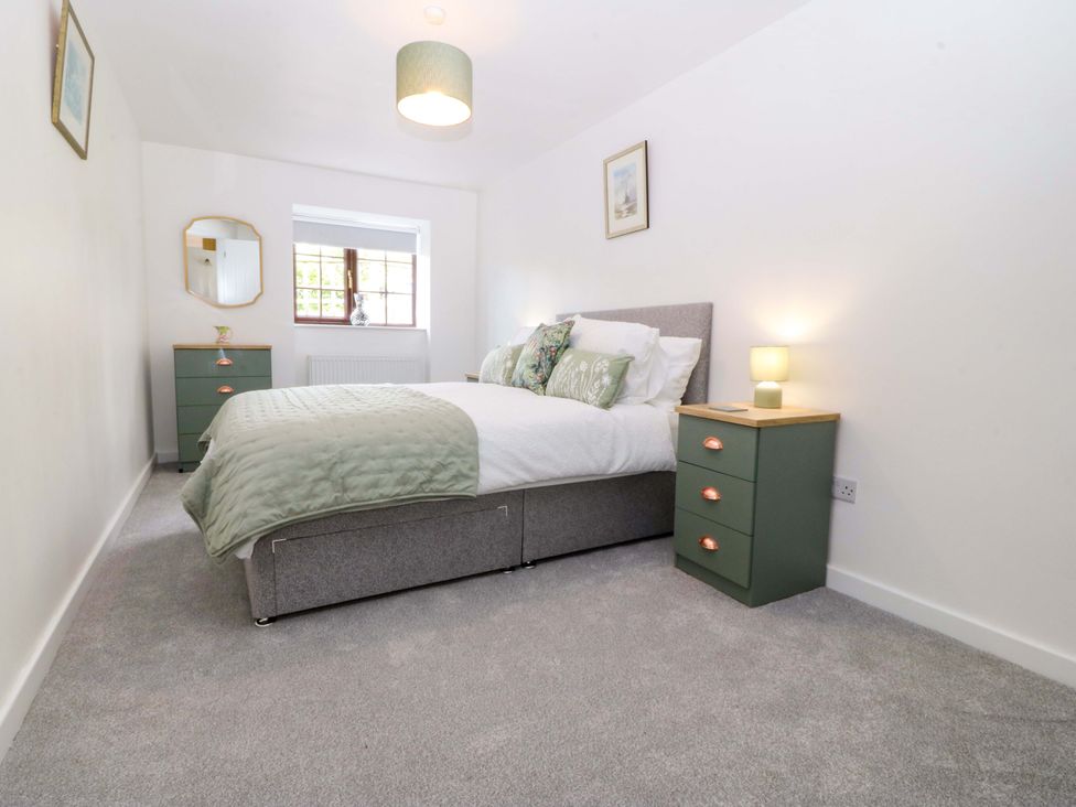A bedroom with a bed and bedside tables at Cil Y Coed in Star near Llanfairpwllgwyngyll