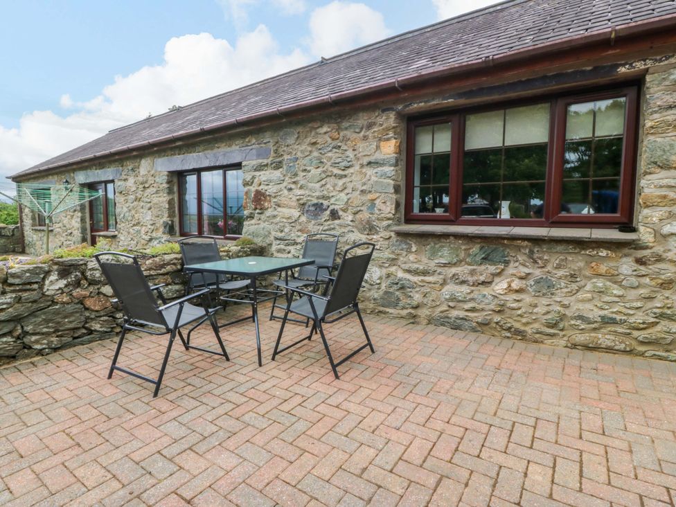 An outdoor seating area with table and chairs at Cil Y Coed Star near Llanfairpwllgwyngyll