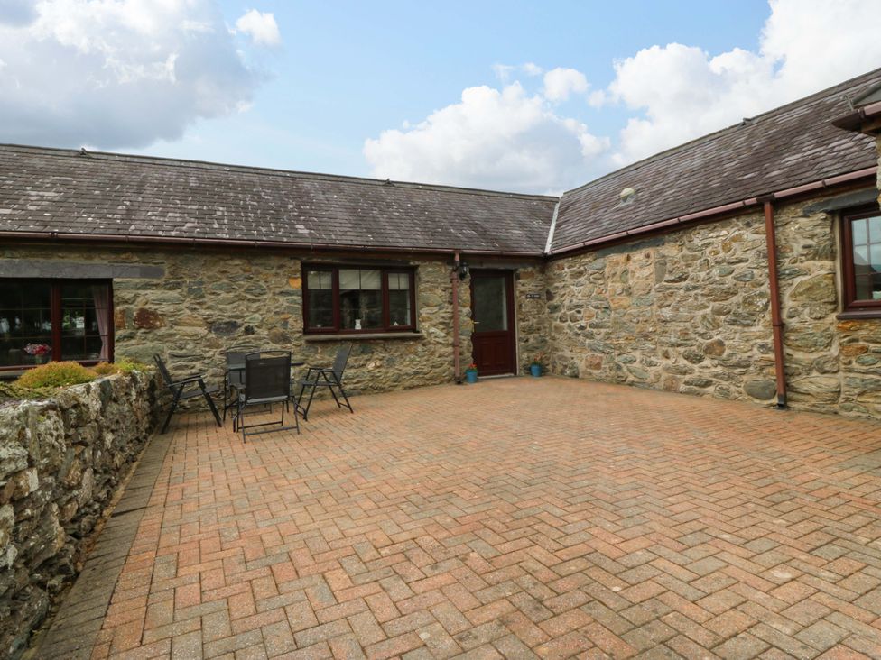 An outdoor area with a table and chairs at Cil Y Coed in Star near Llanfairpwllgwyngyll