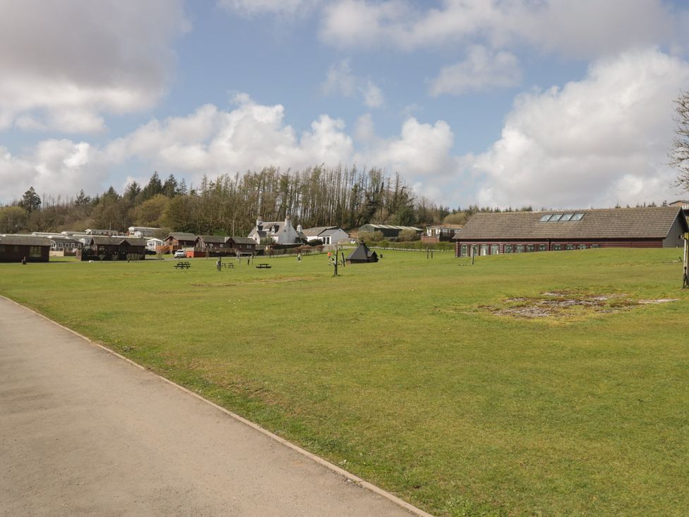 An outdoor area with buildings and green grass at Lochwood Platinum Superior at Three Lochs Holiday Park Newton Stewart