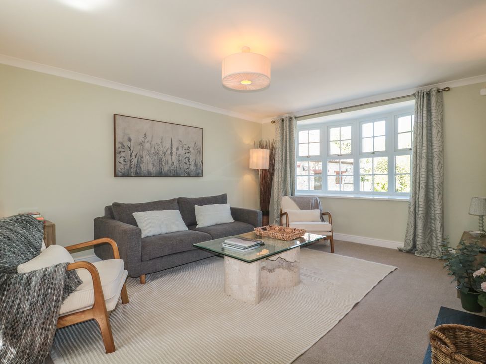 A living room with a sofa and coffee table at The Little Vicarage in Highbridge