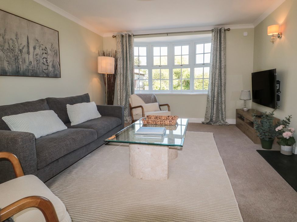 A living room with a sofa and coffee table at The Little Vicarage in Highbridge