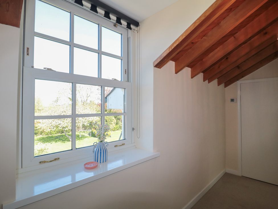 A hallway with a window and a door at The Little Vicarage in Highbridge