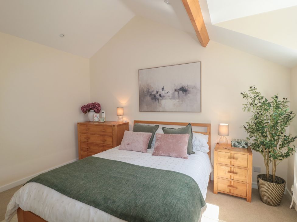 A bedroom with a bed and nightstands at The Little Vicarage in Highbridge