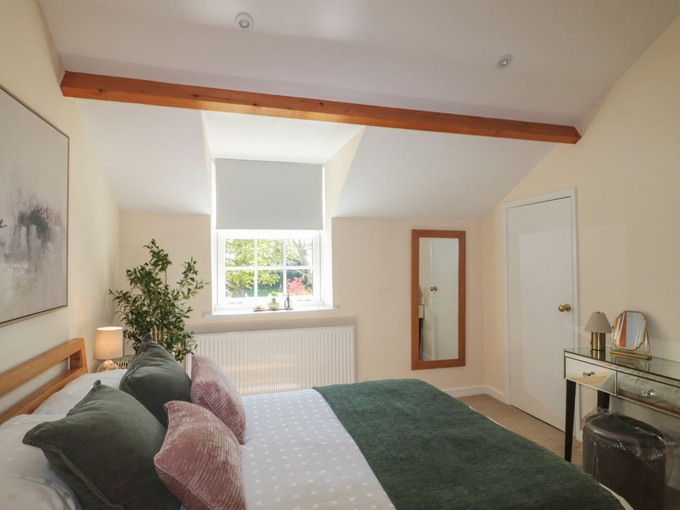 A bedroom with a bed and a window at The Little Vicarage in Highbridge