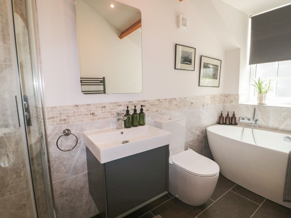 A bathroom with a shower, sink, and bathtub at The Little Vicarage in Highbridge