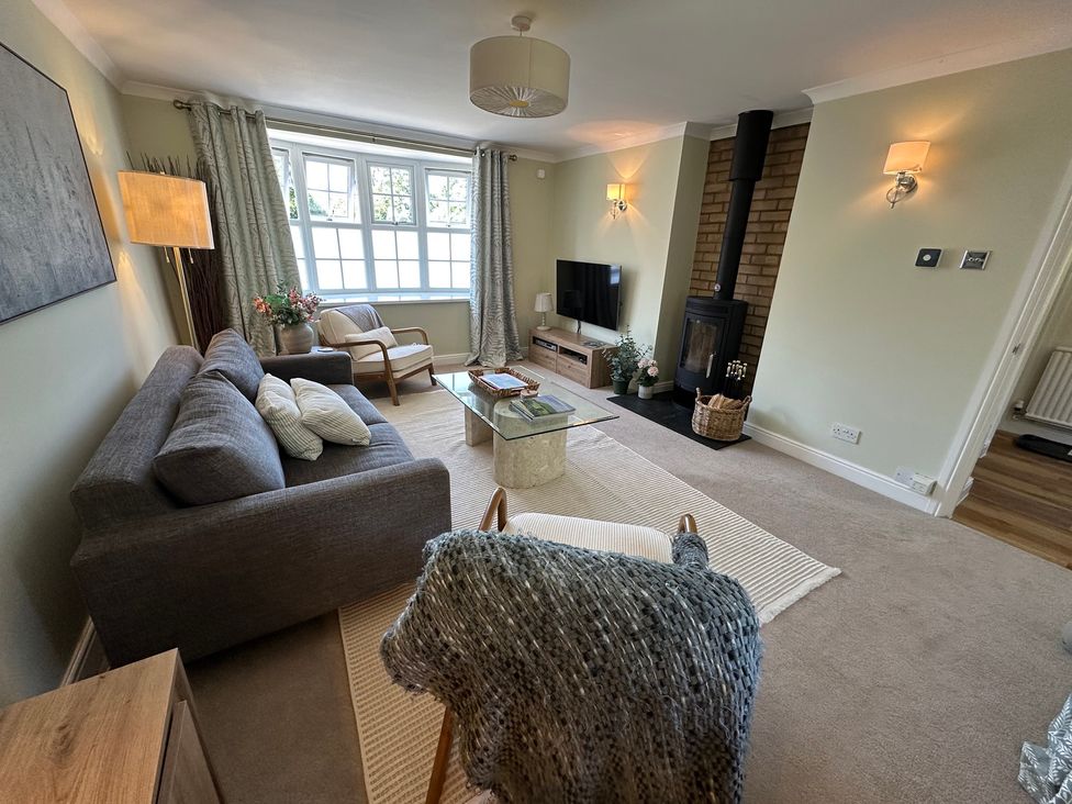 A living room with a sofa and coffee table at The Little Vicarage in Mark