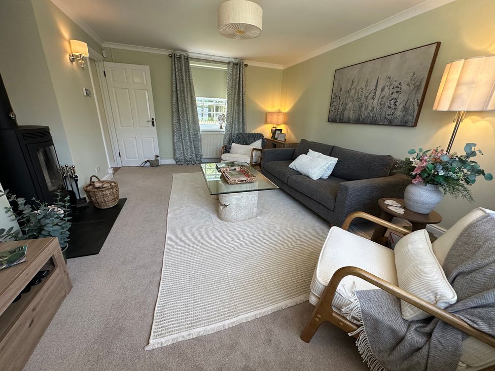 A living room with a sofa and coffee table at The Little Vicarage in Mark