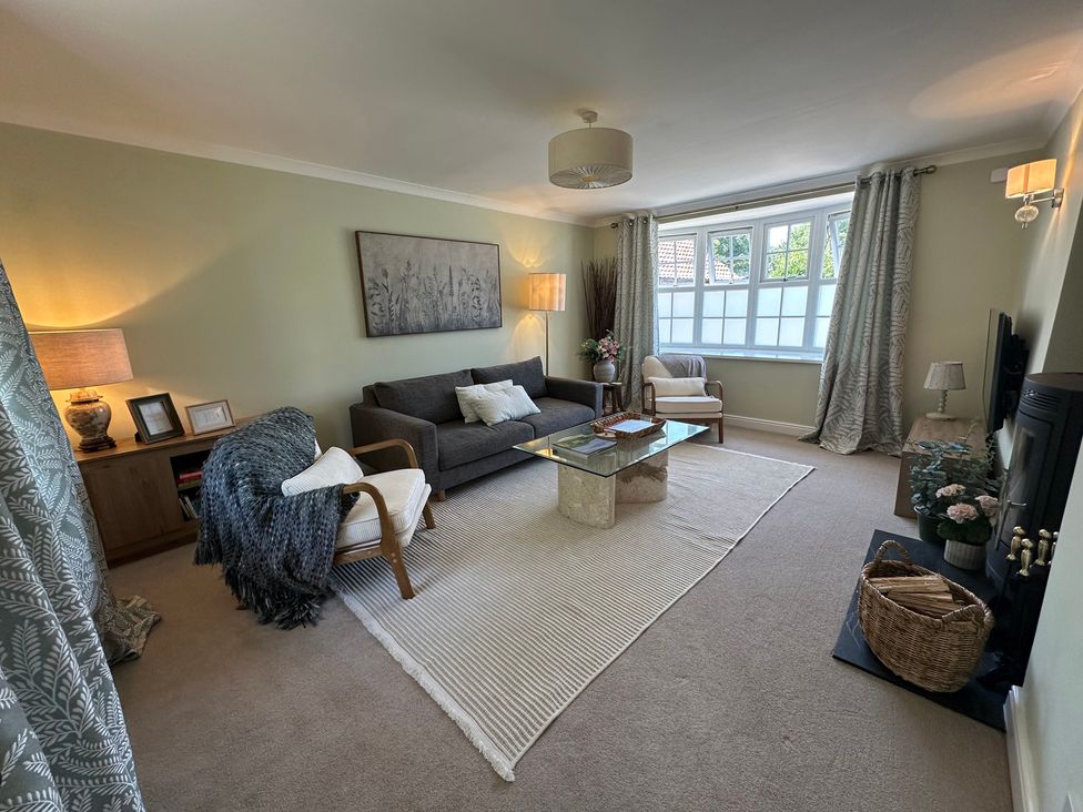 A living room with a sofa and coffee table at The Little Vicarage in Mark