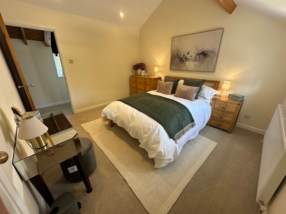 A bedroom with a bed and side tables at The Little Vicarage in Mark