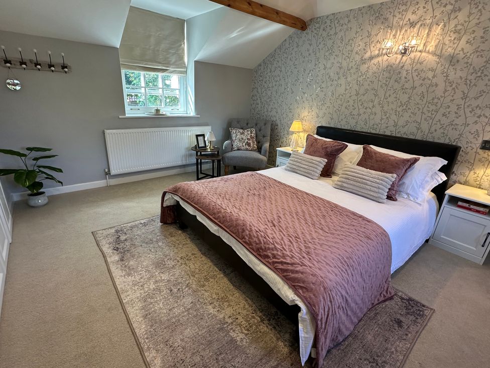 A bedroom with a bed and furniture at The Little Vicarage in Mark
