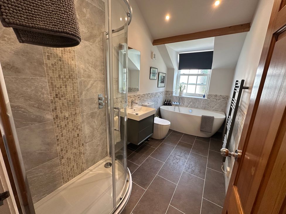 A bathroom with a shower and bathtub at The Little Vicarage in Mark