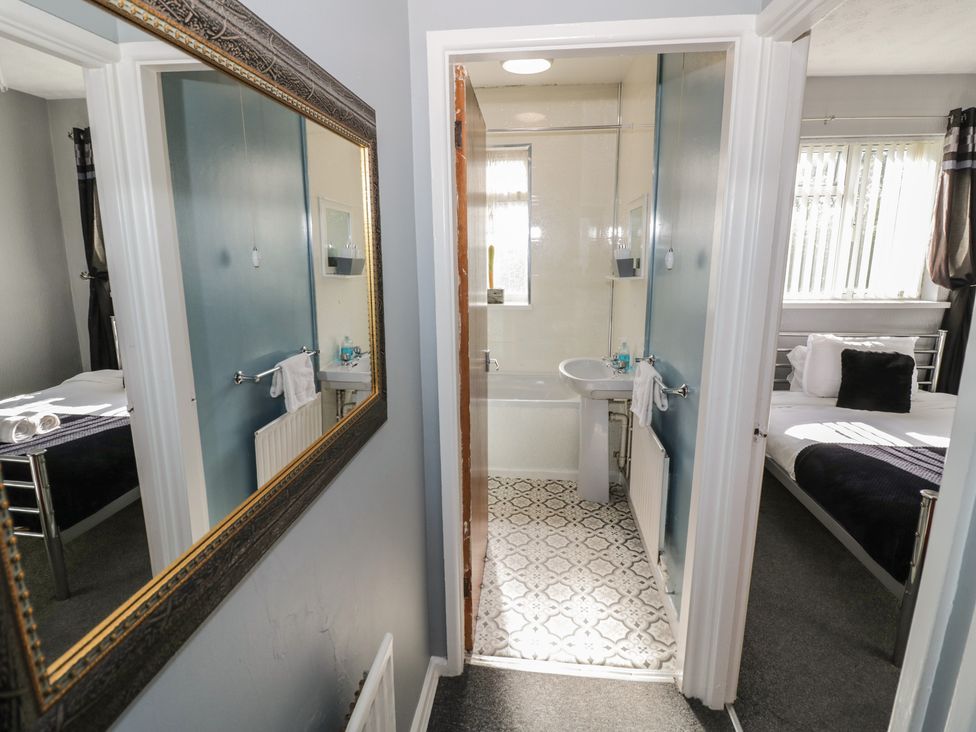 A bathroom with a mirror and sink at 32B Cramp Hill in Darlaston