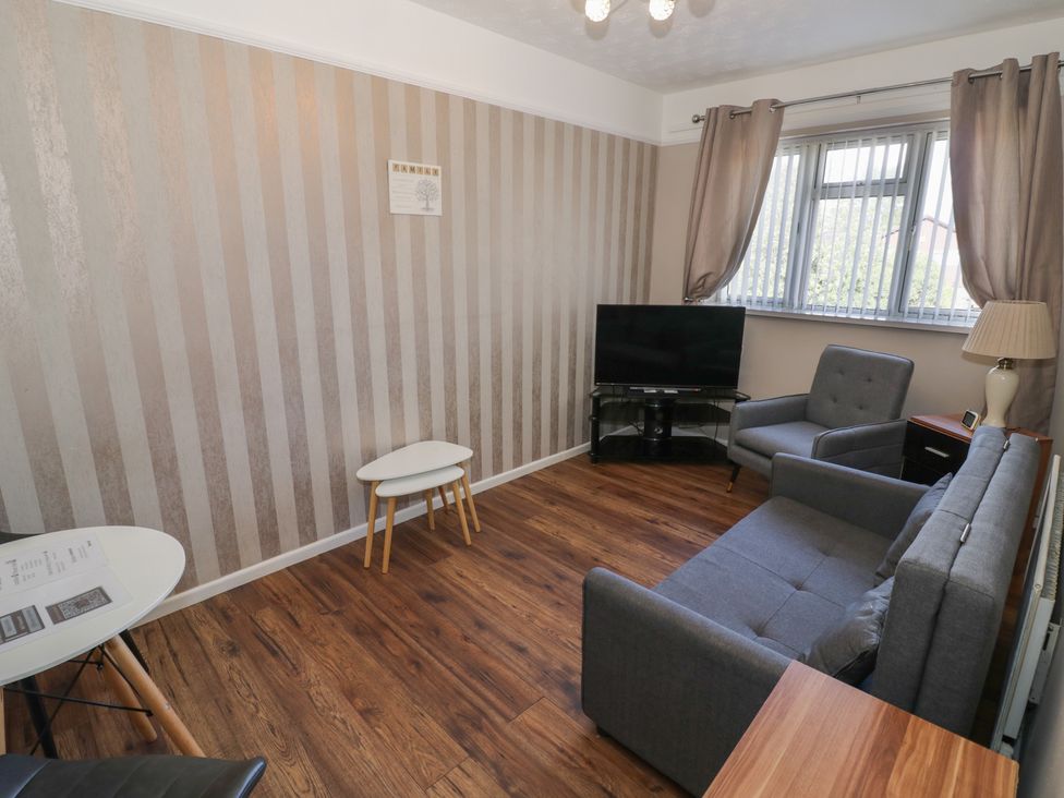 A living room with a sofa and television at 32B Cramp Hill in Darlaston