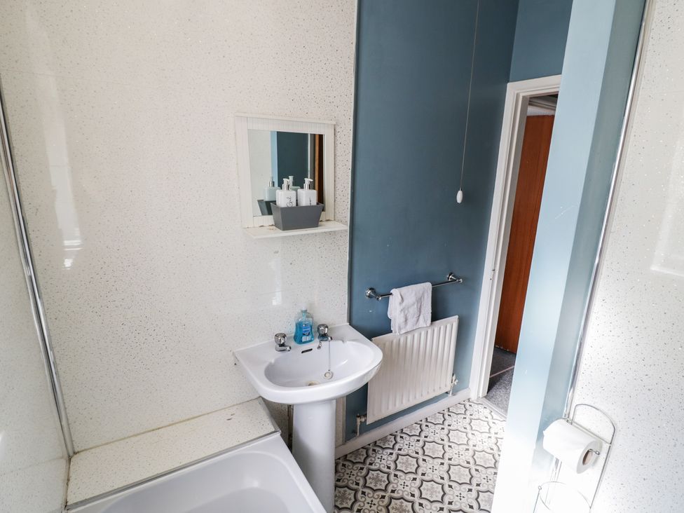 A bathroom featuring a sink and bathtub at 32B Cramp Hill in Darlaston