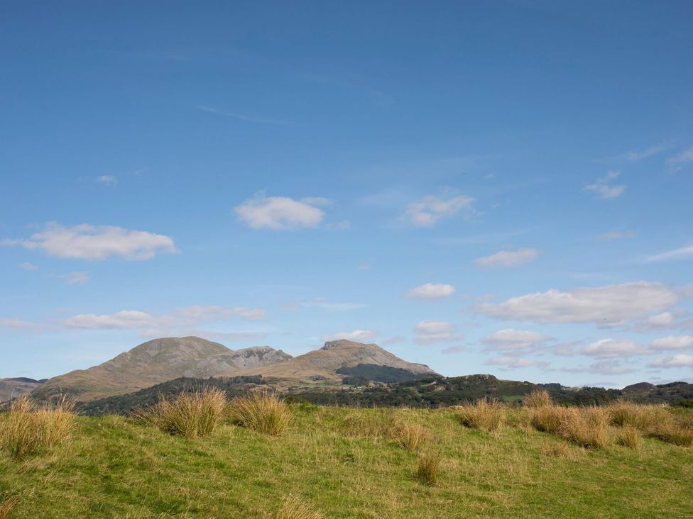 Mountains in a field under a cloudy sky at 2 Bryn Eglwys Prenteg near Porthmadog