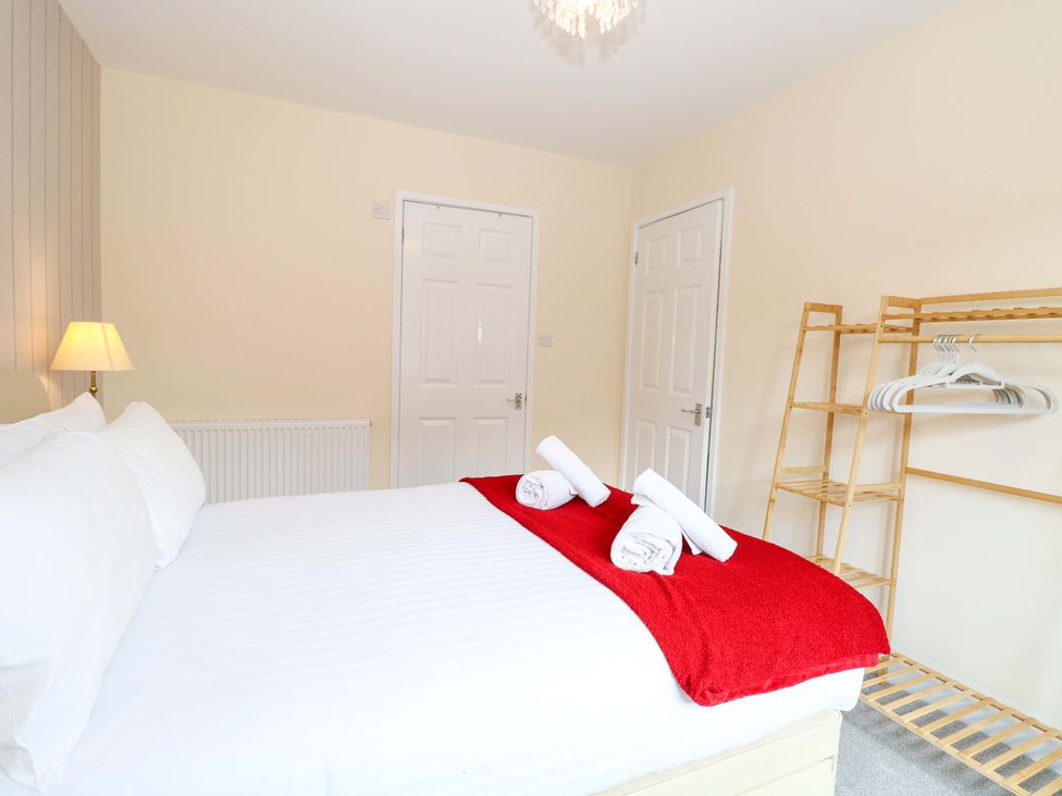 A bedroom with a bed and towels on top at The Mill House Gardens