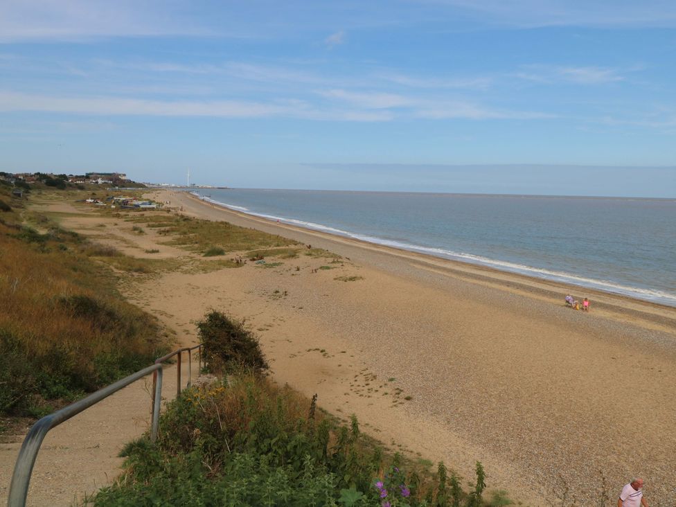 A beach with sand and ocean at The Mill House Gardens in 