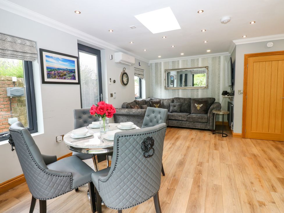 A dining room with a table and chairs at Caesars Lodge Houghton Bank near Heighington
