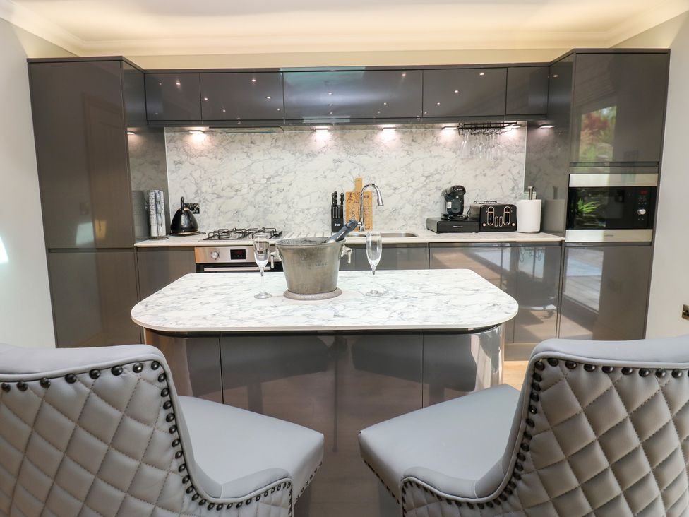 A kitchen with marble countertop and appliances at Caesars Lodge Houghton Bank near Heighington