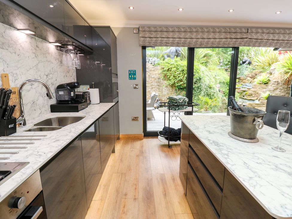A kitchen with modern appliances and sliding door to garden at Caesars Lodge in Houghton Bank near Heighington