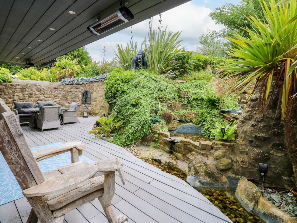 A garden with decking, seating area and water feature at Caesars Lodge, Houghton Bank near Heighington
