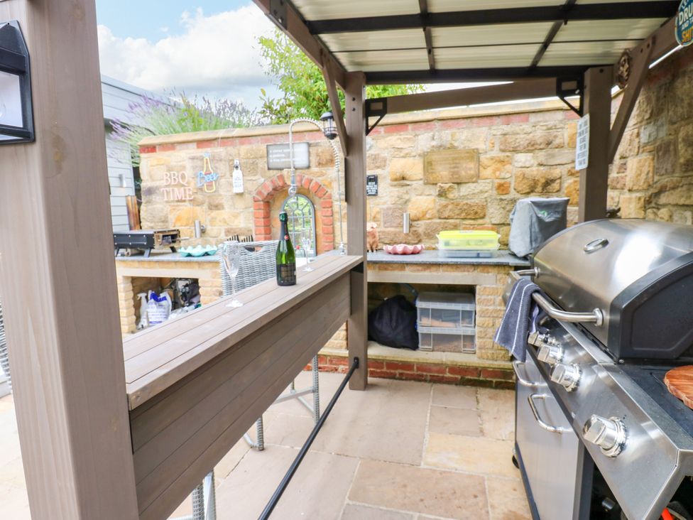 An outdoor kitchen with a barbecue grill and countertop at Caesars Lodge Houghton Bank near Heighington