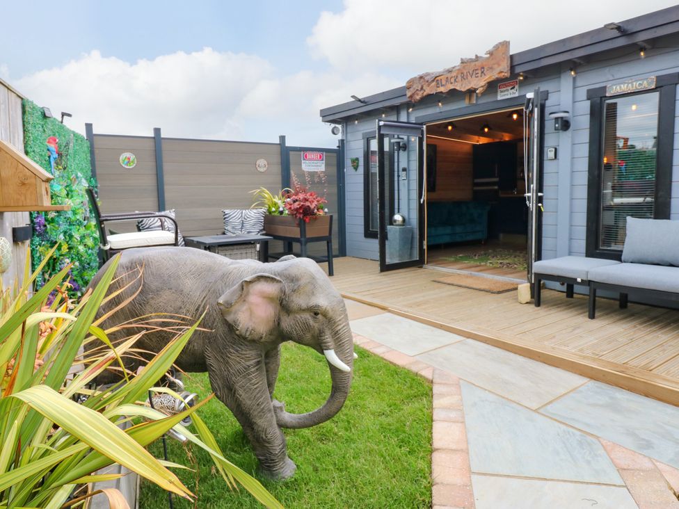 An outdoor patio area with a statue of an elephant at Black River in Houghton Bank near Heighington